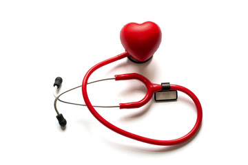 Close up red stethoscope and heart on membrane isolated on white background. Diagnosis and treatment in cardiology. Medicine concept. Copy space for text.
