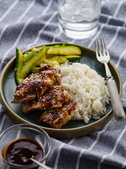 Hoisin Chicken. Traditional Asian cuisine. Chicken with sauce, rice and pickled cucumbers.