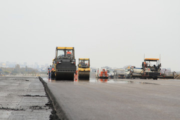 A shot of drum rollers and paving machines