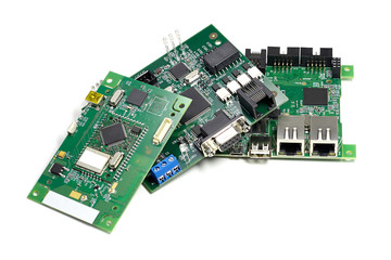 Set of electronic printed circuit boards with microchips, leds and other components, angled view,...