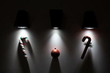 Christmas decorative decorations are illuminated from beneath from above by lamps on a background a...