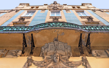 Detail of old classic building and architecture with sculptures, windows and balcony in historical center of belgrade, serbia
