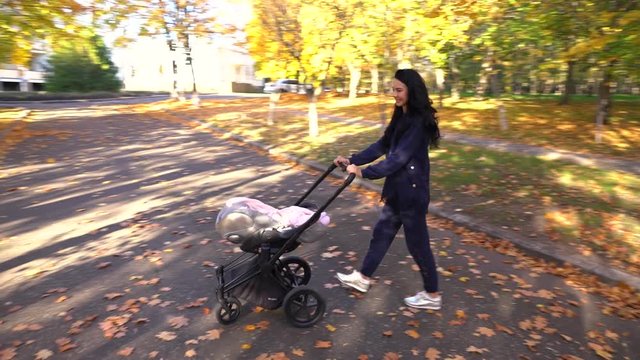 Mother with baby stroller walking around