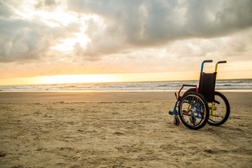 Fototapeta premium sunset childlike wheelchair horizon sand