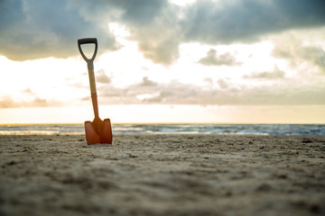 shovel in the sand of the beach © mailsonpignata