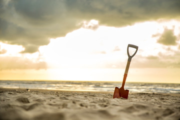 shovel in the sand of the beach
