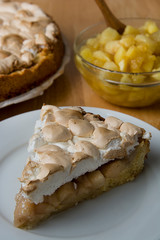 Piece of apple or pear cake, pie, with meringue on the plate. 