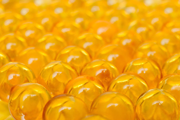 Fish oil OMEGA3 DHA EPA in yellow soft gelatin capsules pills arrange to be fish shape isolate on white background with copy space for text. gelatinous capsule fish fat