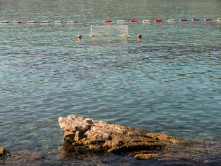 Water polo metal goal on sea with mountains background front view