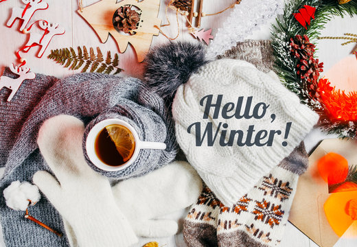 Warm, winter clothes. Seasonal wardrobe. Inscription on the hat: Hello Winter!