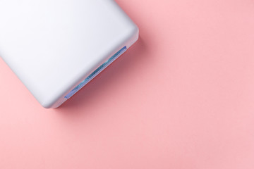 UV lamp lights for nails on pink background. Top view. Flat lay. Copy space. Minimal creative concept. Pink background in pastel colours