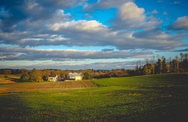 Farm landscape with blue sky and clouds