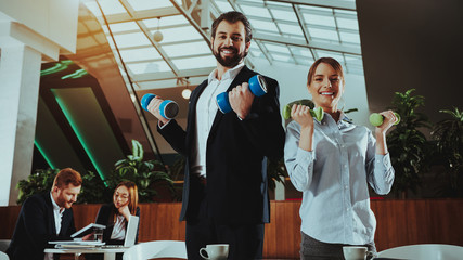 Happy Office Workers Working with Dumbbells