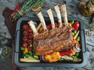 Grilled roasted rack of lamb,veal with vegetables on the baking sheet