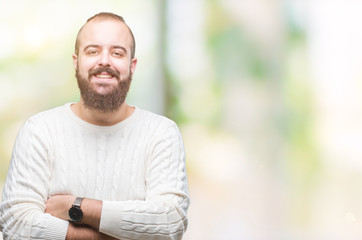 Fototapeta premium Young caucasian hipster man wearing winter sweater over isolated background happy face smiling with crossed arms looking at the camera. Positive person.