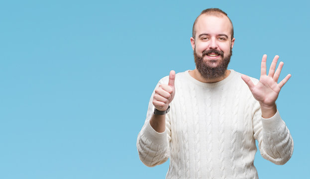 Young caucasian hipster man wearing winter sweater over isolated background showing and pointing up with fingers number six while smiling confident and happy.