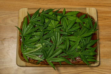 Marijuana gingerbread with orange briar marmalade and fresh green leafs