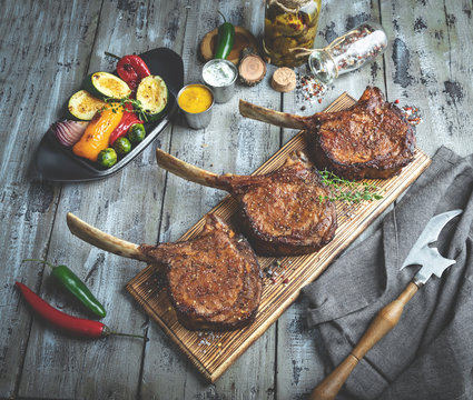 Grilled lamb,veal meat chops with vegetables on a serving board. Rustic food concept