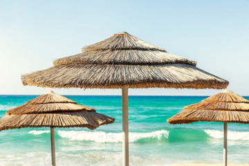 Sun umbrellas on the beach, turquoise sea