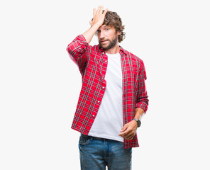 Handsome hispanic model man over isolated background surprised with hand on head for mistake,...