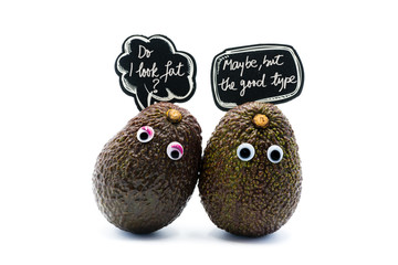 Naklejka premium Romantic avocados couple with googly eyes and speech bubble as man and woman, funny food concept for creative projects