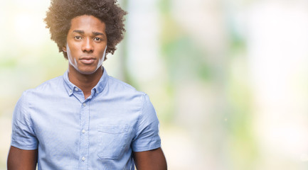 Afro american man over isolated background with serious expression on face. Simple and natural looking at the camera.