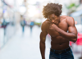 Fototapeta na wymiar Afro american shirtless man showing nude body over isolated background feeling unwell and coughing as symptom for cold or bronchitis. Healthcare concept.