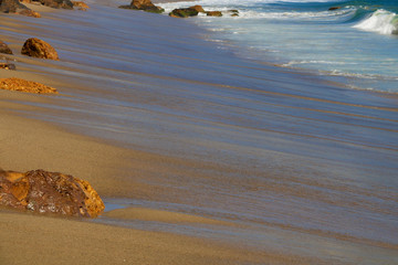 Soft wave of the sea on a sandy beach. Los Angeles, USA.