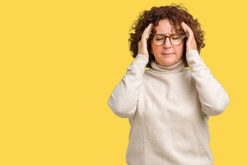 Beautiful middle ager senior woman wearing turtleneck sweater and glasses over isolated background with hand on head for pain in head because stress. Suffering migraine.