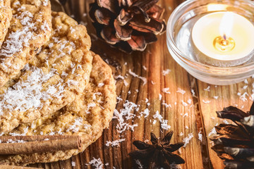 Homemade oatmeal cookies, cinnamon and anise seeds. baking on a wooden rustic table, served with winter accessories. Winter holiday still life Christmas or New Year card