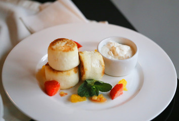 Macro photo of delicious bright cheese cakes with jam and sour