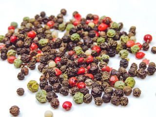 A mixture of pepper in the form of peas on a bright table