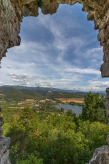 Beautiful lake Piediluco view and the ancient town Labro on the hill from the window of an old ruined castle (Rocca di Piediluco). Terni, Umbria, Italy