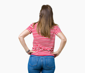 Middle age mature woman wearing casual t-shirt over isolated background standing backwards looking away with arms on body