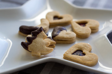 Christmas sweets and cookies made from shortcrust pastry, various shapes filled with marmalade and decorated with chocolate