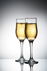 Two elegant glasses with sparkling champagne Holiday card Christmas, New Year, wedding. Celebration concept advertising design