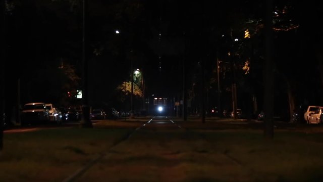 Hand held shot of a New Orleans streetcar at night