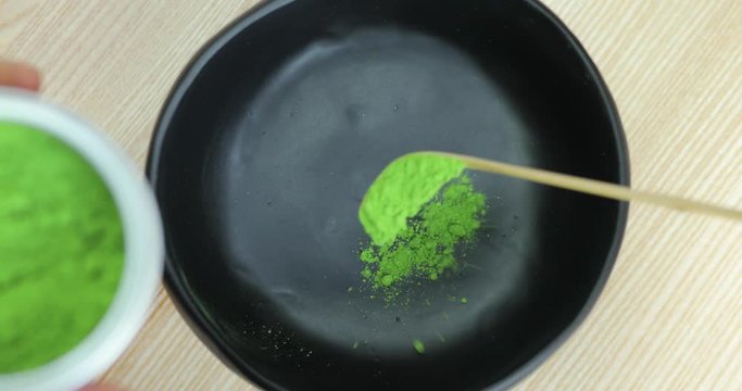 Add matcha green tea powder into bowl