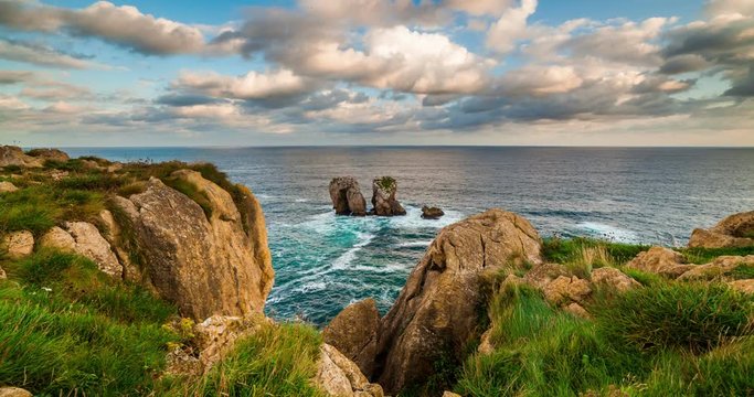 Natural arch of Playa de la Arnia at sunrise, Cantabria, Spain.