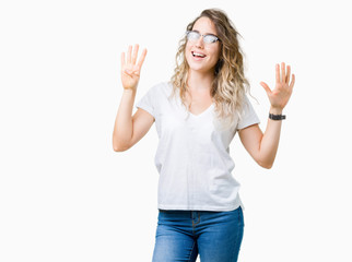 Beautiful young blonde woman wearing glasses over isolated background showing and pointing up with fingers number nine while smiling confident and happy.