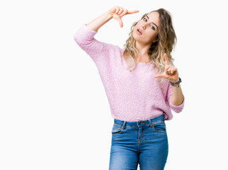 Beautiful young blonde woman over isolated background smiling making frame with hands and fingers with happy face. Creativity and photography concept.