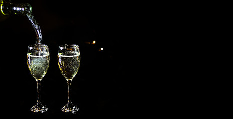 New year background. Two glasses of champagne isolated on black.