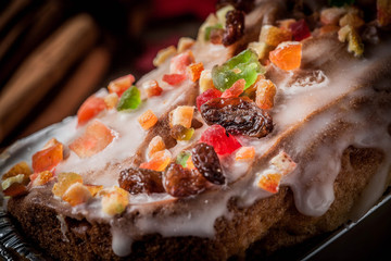 Christmas homemade fruitcake on the wooden background.