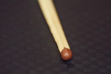 Close-up of matches, Brown, on a black background in a cage.