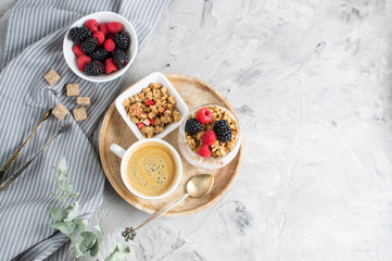 Healthy Breakfast Cup of Coffee Greek Yogurt with Homemade Granola, Berries, Raspberries and Blackberries Work Laptop Morning Concept