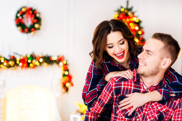 Close-up of a girl with a beautiful makeup that hugs a guy behin