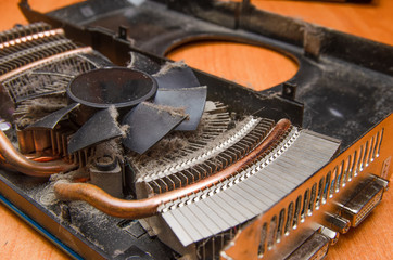 Dust on the computer pc processor cooler with mainboard and computer case fragment. Selective focus. Macro photo. Video card.