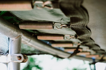 Obraz premium Close up of trampoline springs, bottom view