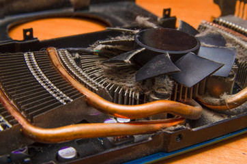 Dust on the computer pc processor cooler with mainboard and computer case fragment. Selective...