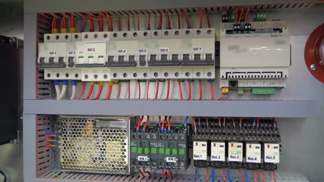 Electrical panel with multiple switches, wires, short circuit protection devices and electricity meter. Shot in motion